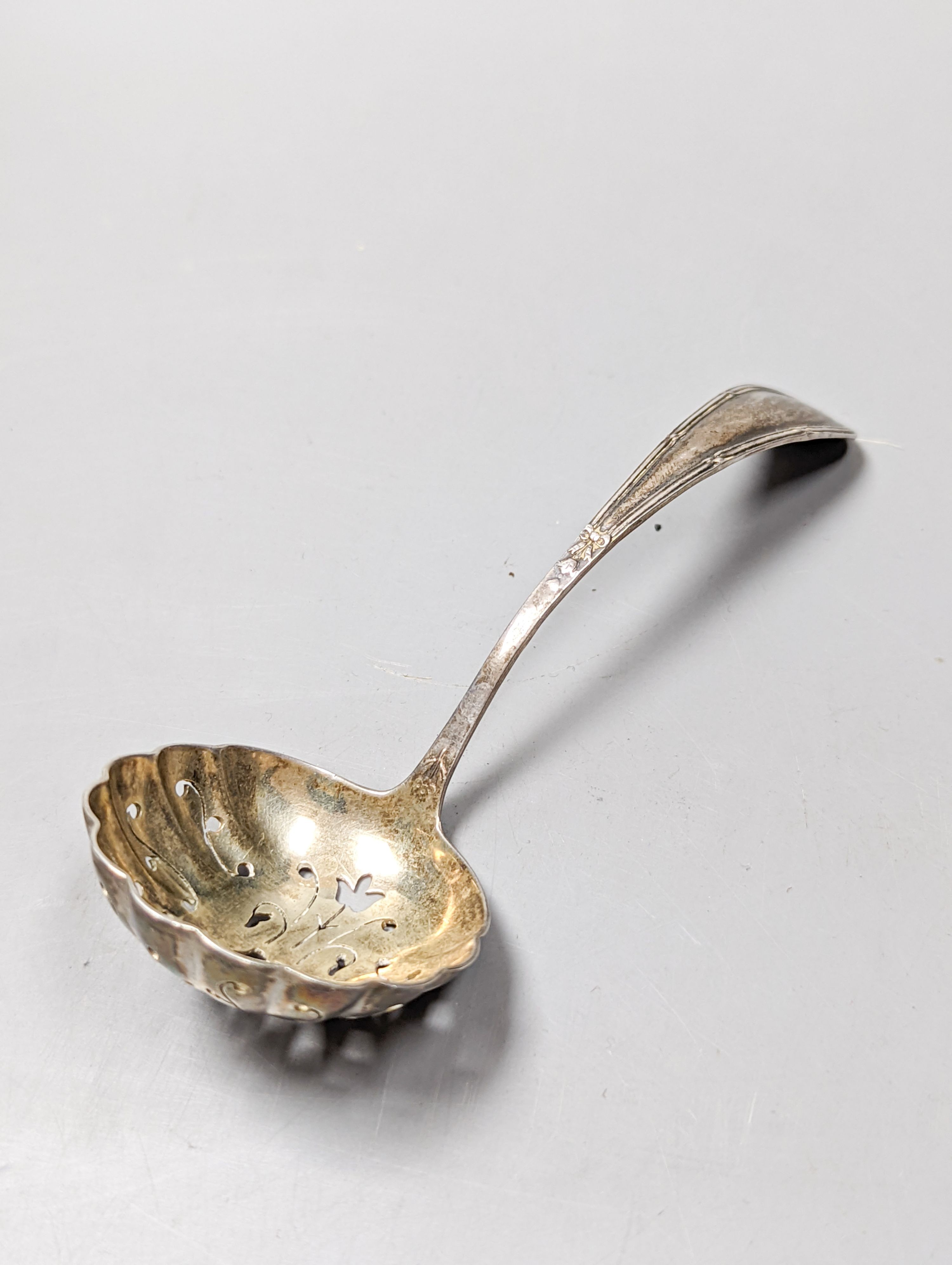 A George V silver sauceboat by Mappin & Webb, Birmingham, 1911, an Edwardian silver tri-handled bowl, a late Victorian repousse silver box and a George V silver sifter spoon, 11oz.